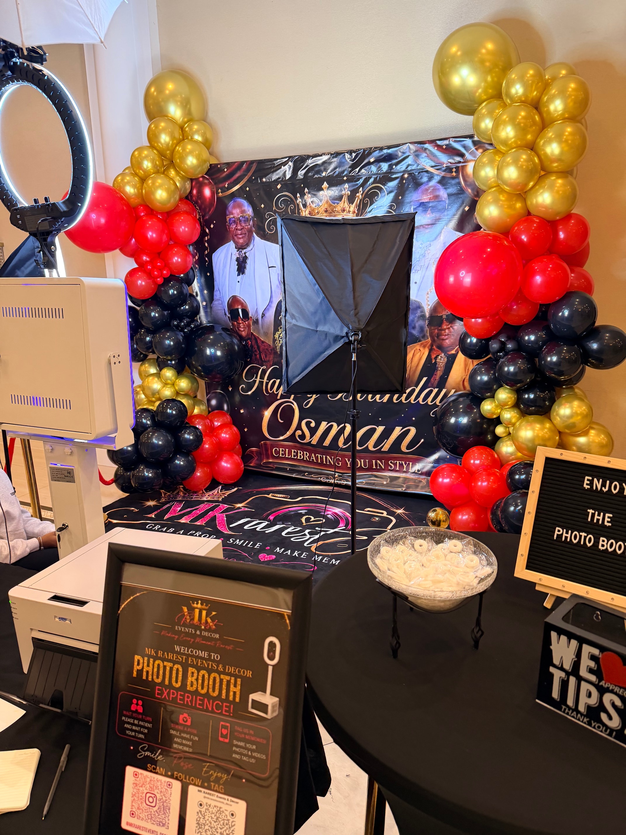 Photo booth setup with ring light and birthday backdrop